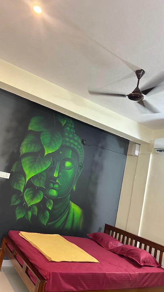 Room with wooden bed and green wall artwork